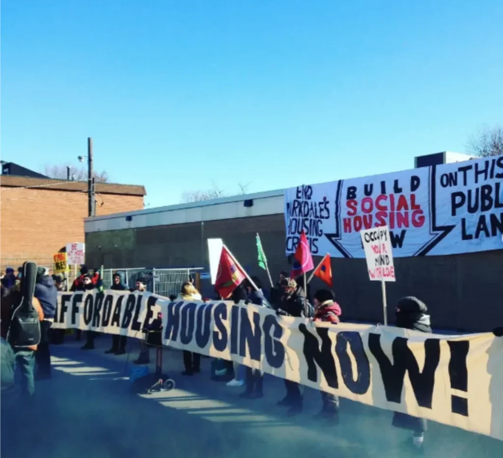 Protesters with an affordable housing now banner