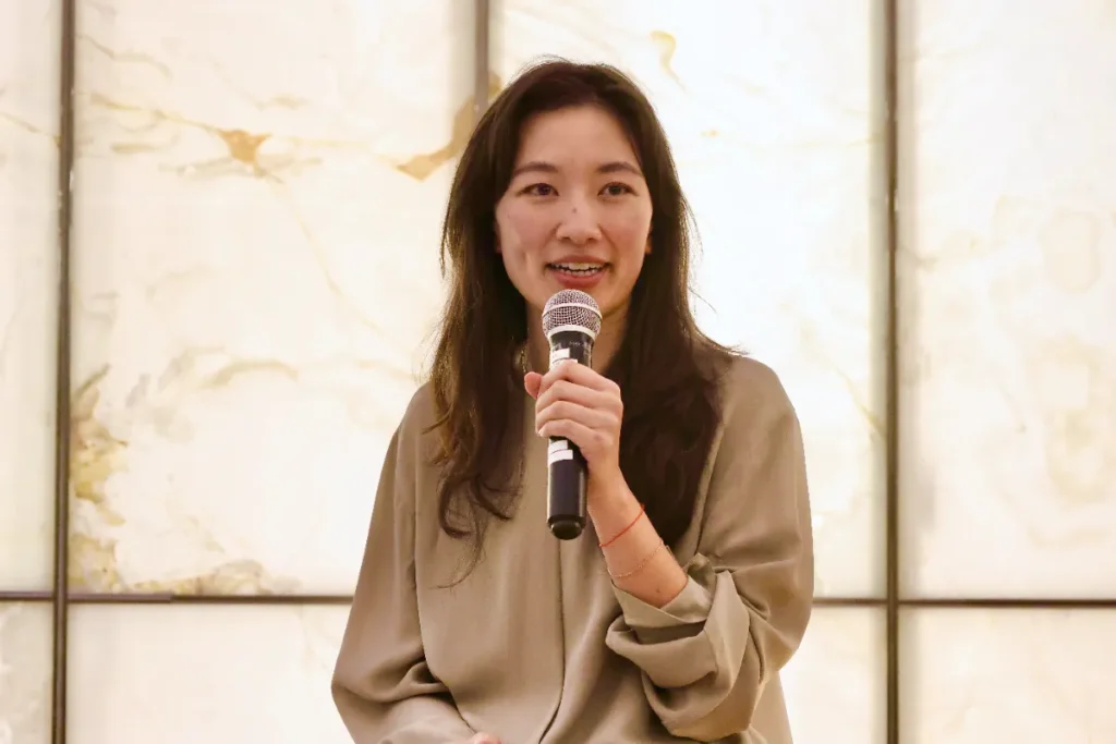 A panel speaker holding a mic