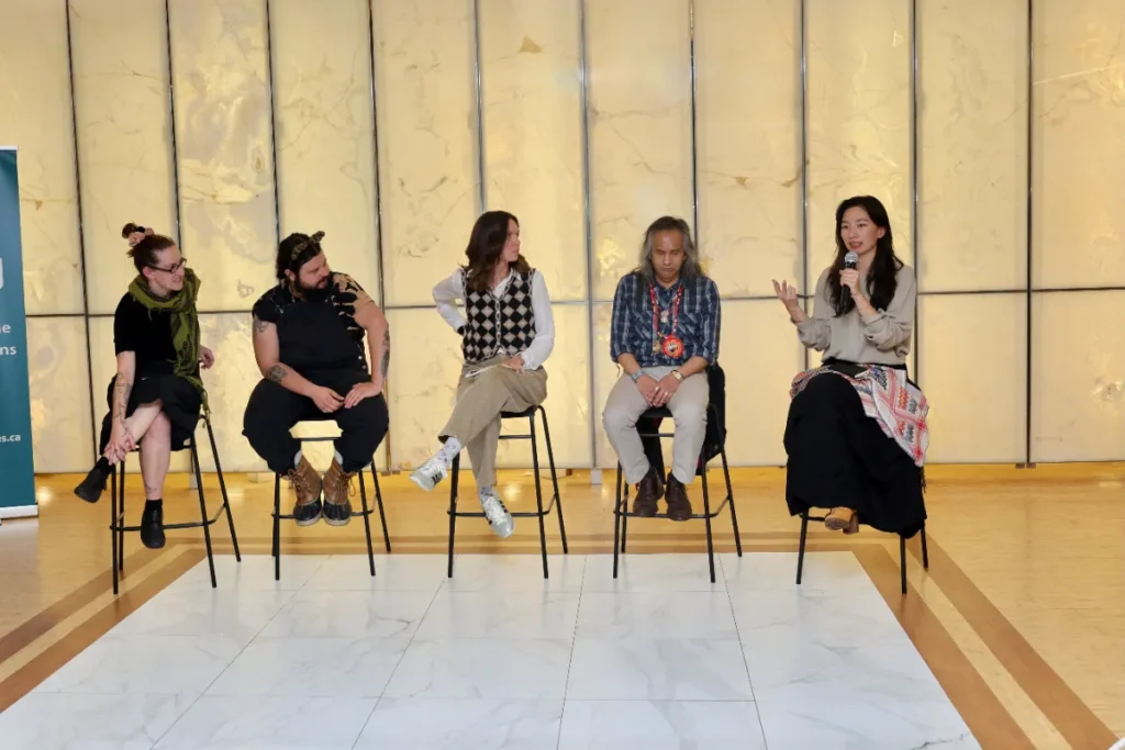 Group photo of panel speakers on stage
